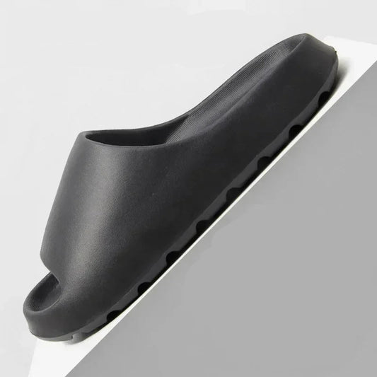 Black slip-resistant shoe sole with detailed texture on a gray background