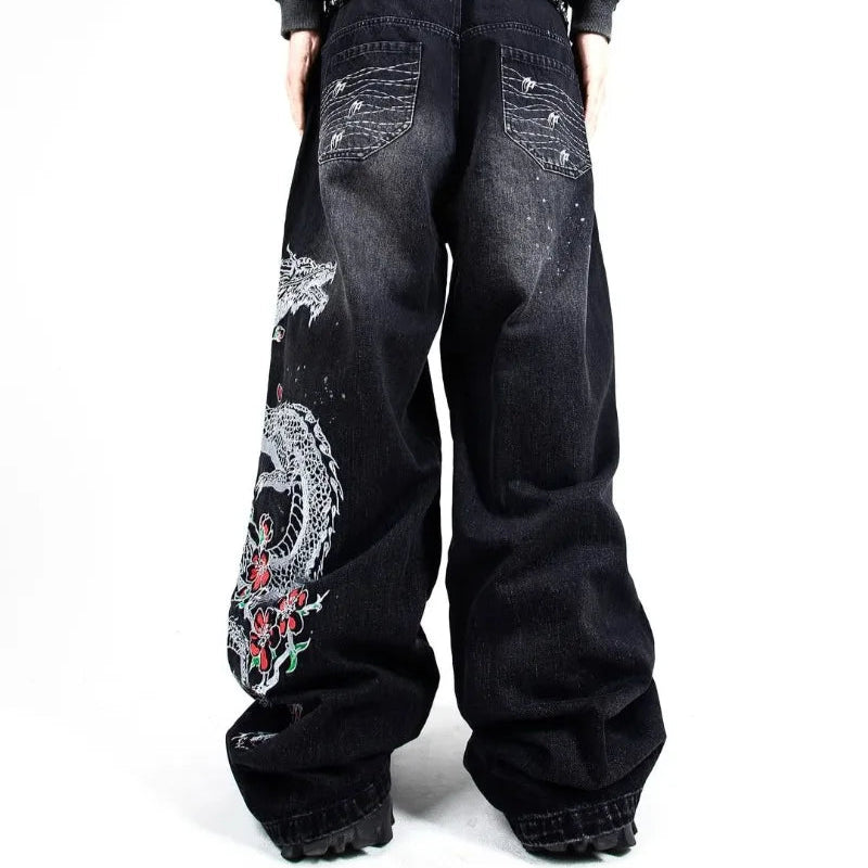 Black jeans with floral embroidery on a white background