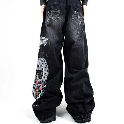 Black jeans with floral embroidery on a white background