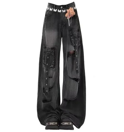Black distressed jeans with decorative elements on a white background