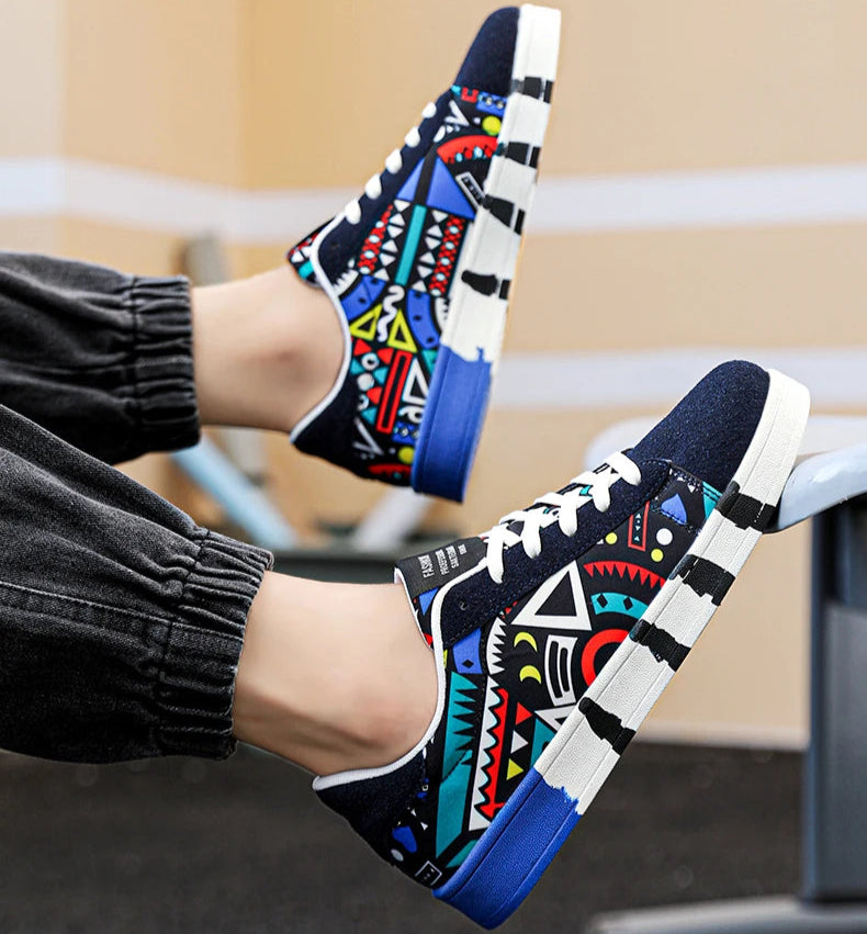 Colorful patterned sneakers worn by a person sitting on a bench.