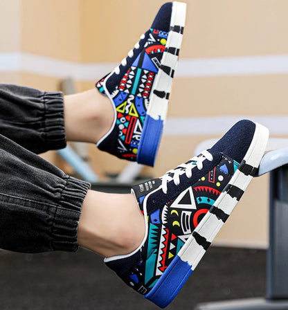 Colorful patterned sneakers worn by a person sitting on a bench.