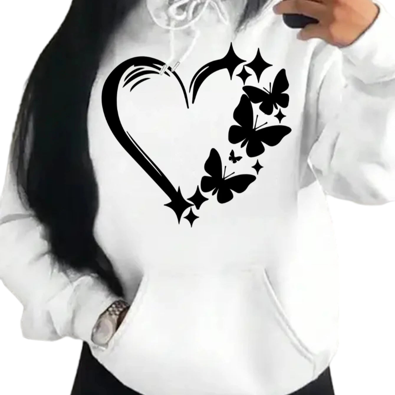 White hoodie with black heart and butterfly design worn by a person.