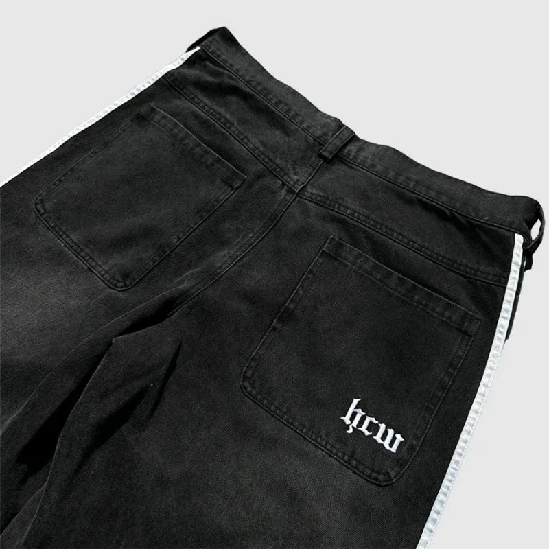 Black pants with a visible brand logo on a light gray background