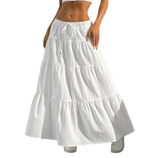 White tiered skirt worn by a person against a neutral background