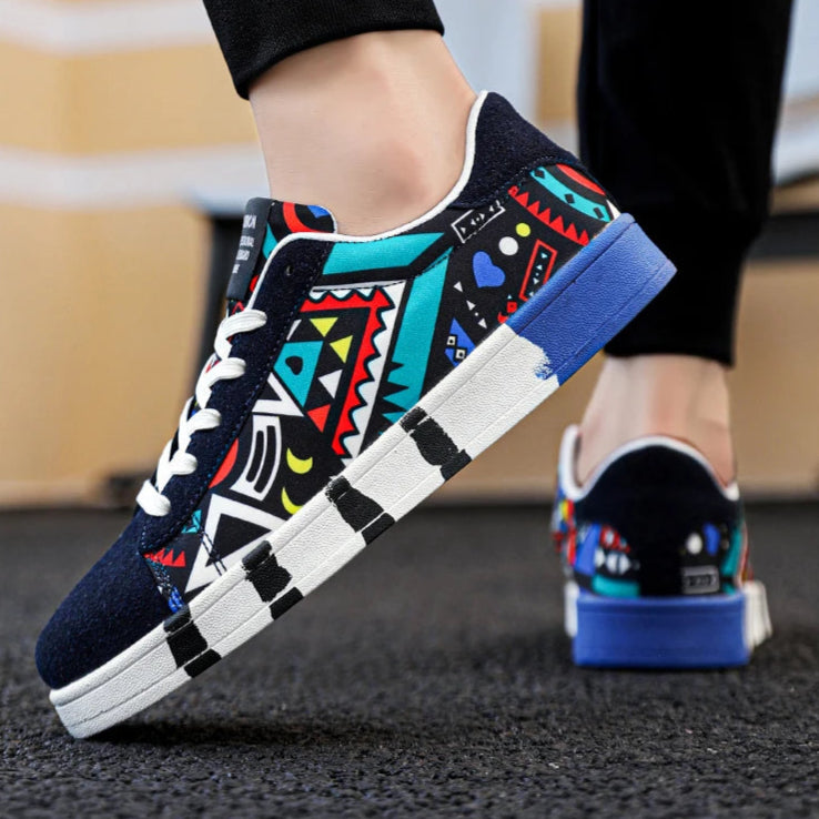 Colorful sneakers with geometric patterns worn by a person on a blurred background