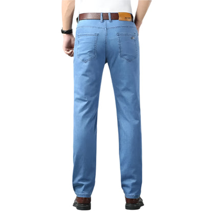 Person wearing blue jeans on a gray background