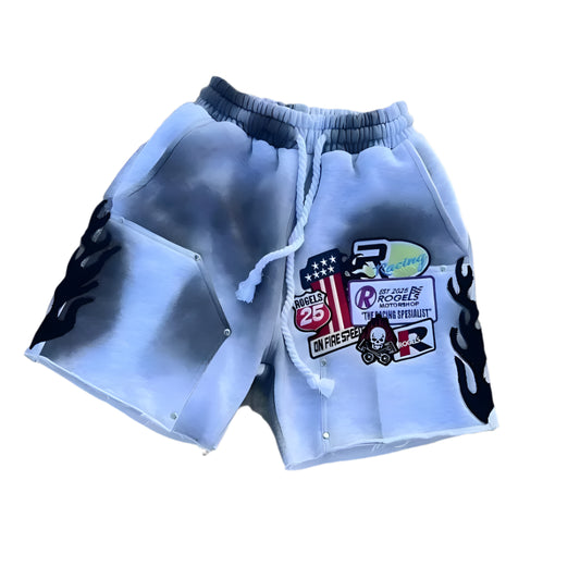 White shorts with black flame designs and visible branding on a gray background