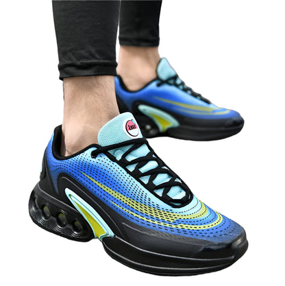 Blue and black sneakers with green accents worn on a road.