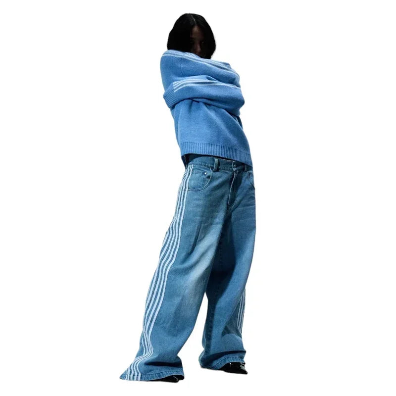 Person wearing a blue hoodie and jeans with white stripes on a white background