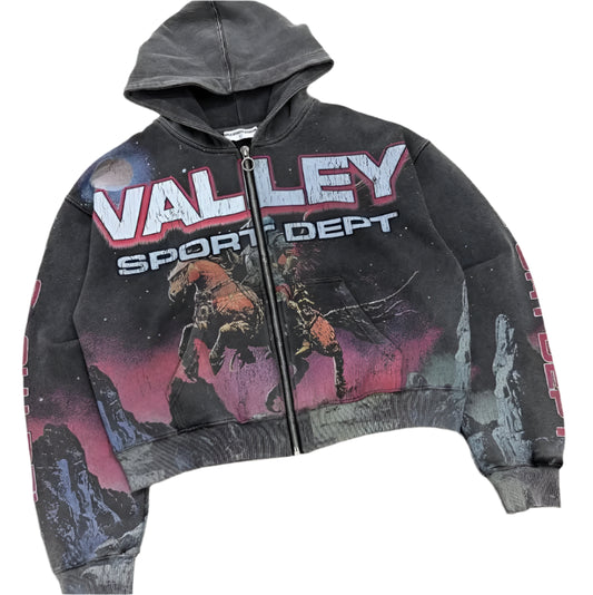 Black hoodie with 'Valley Sport Dept' text and graphic design on a concrete floor.