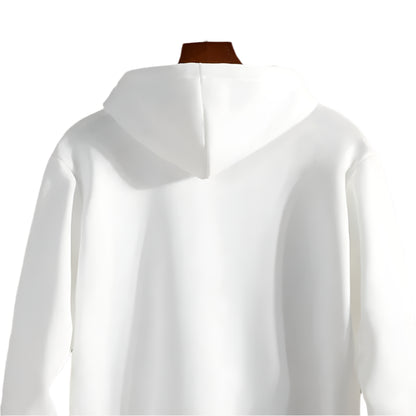White hoodie on a mannequin against a stone wall background