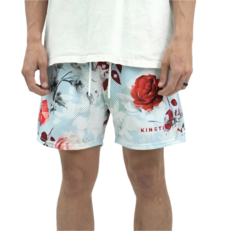 Person wearing floral shorts with a white background