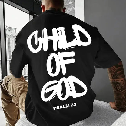 Person wearing a black sweatshirt with 'Child of God' text, Psalm 23, sitting indoors.