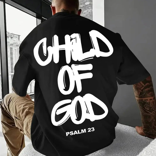 Person wearing a black sweatshirt with 'Child of God' text, Psalm 23, sitting indoors.