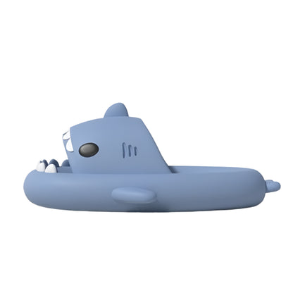 Blue shark-shaped inflatable pool float on a light beige background