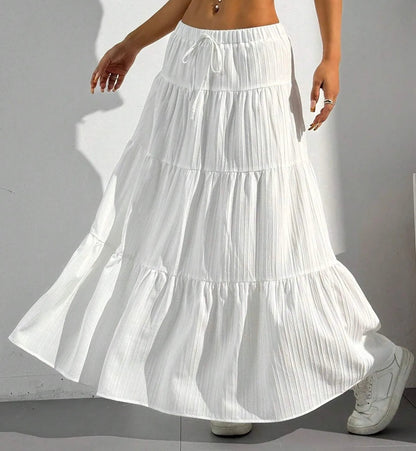 White tiered skirt worn by a person on a plain background