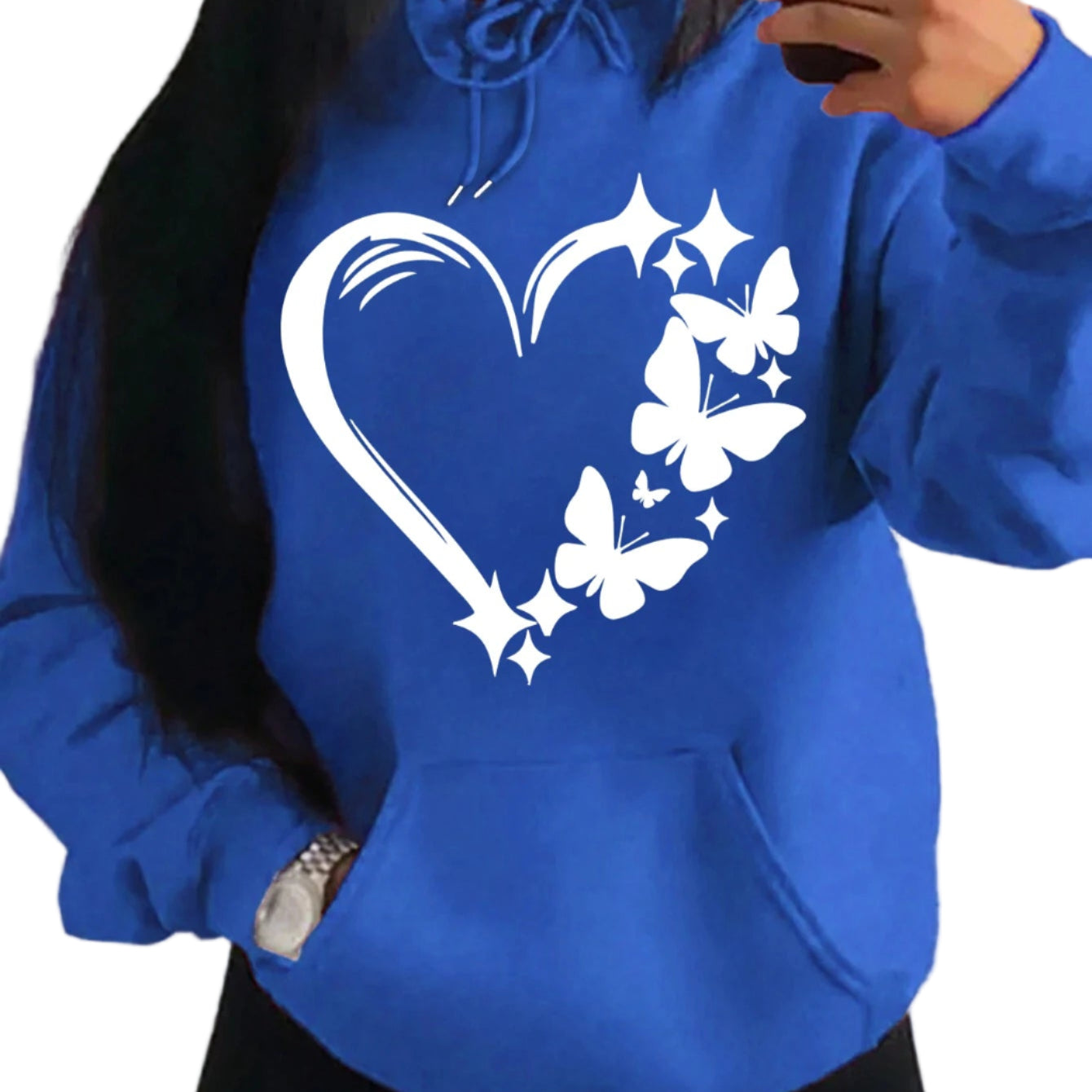Blue hoodie with a white heart and butterfly design worn by a person.