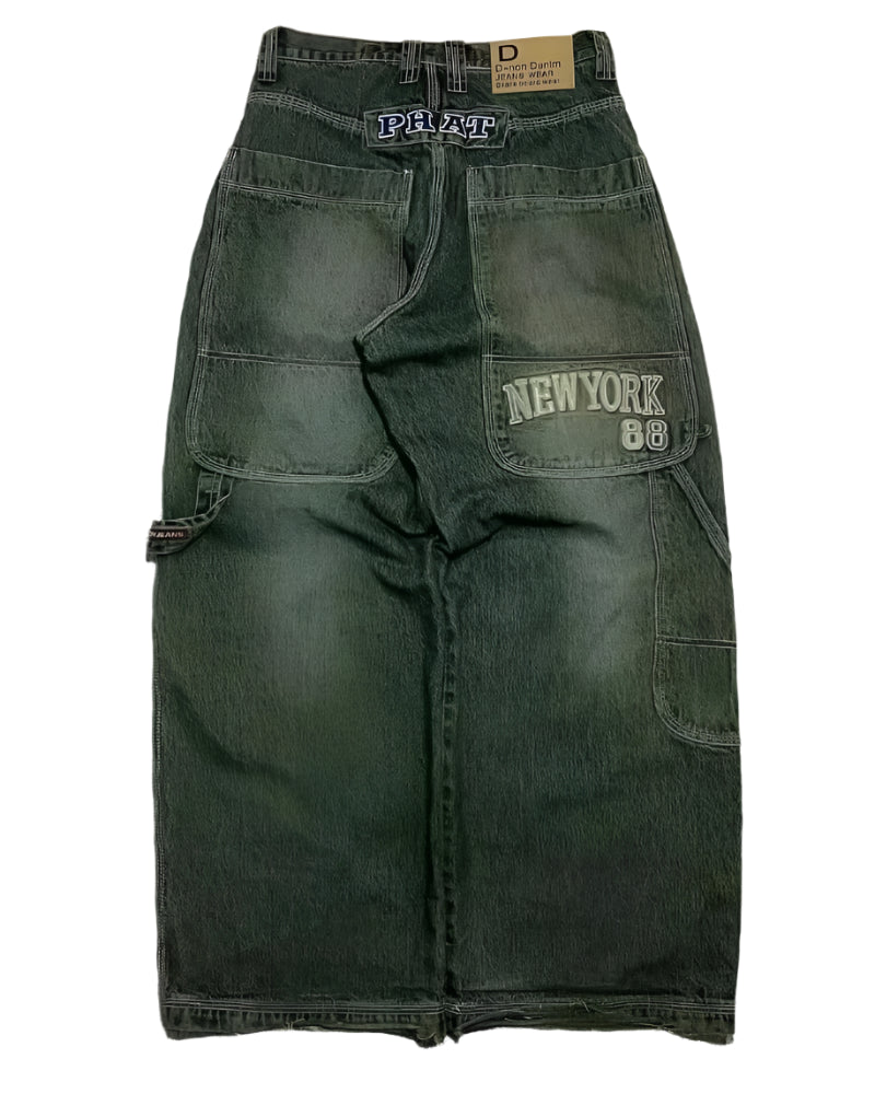 Green cargo pants with 'New York 88' patch on a textured surface
