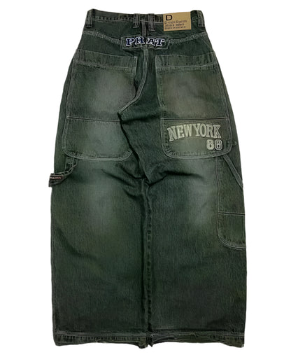 Green cargo pants with 'New York 88' patch on a textured surface