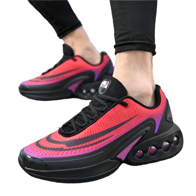 Red and black sneakers with purple accents worn on a street.