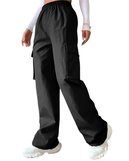 Person wearing black high-waisted pants with a plain background