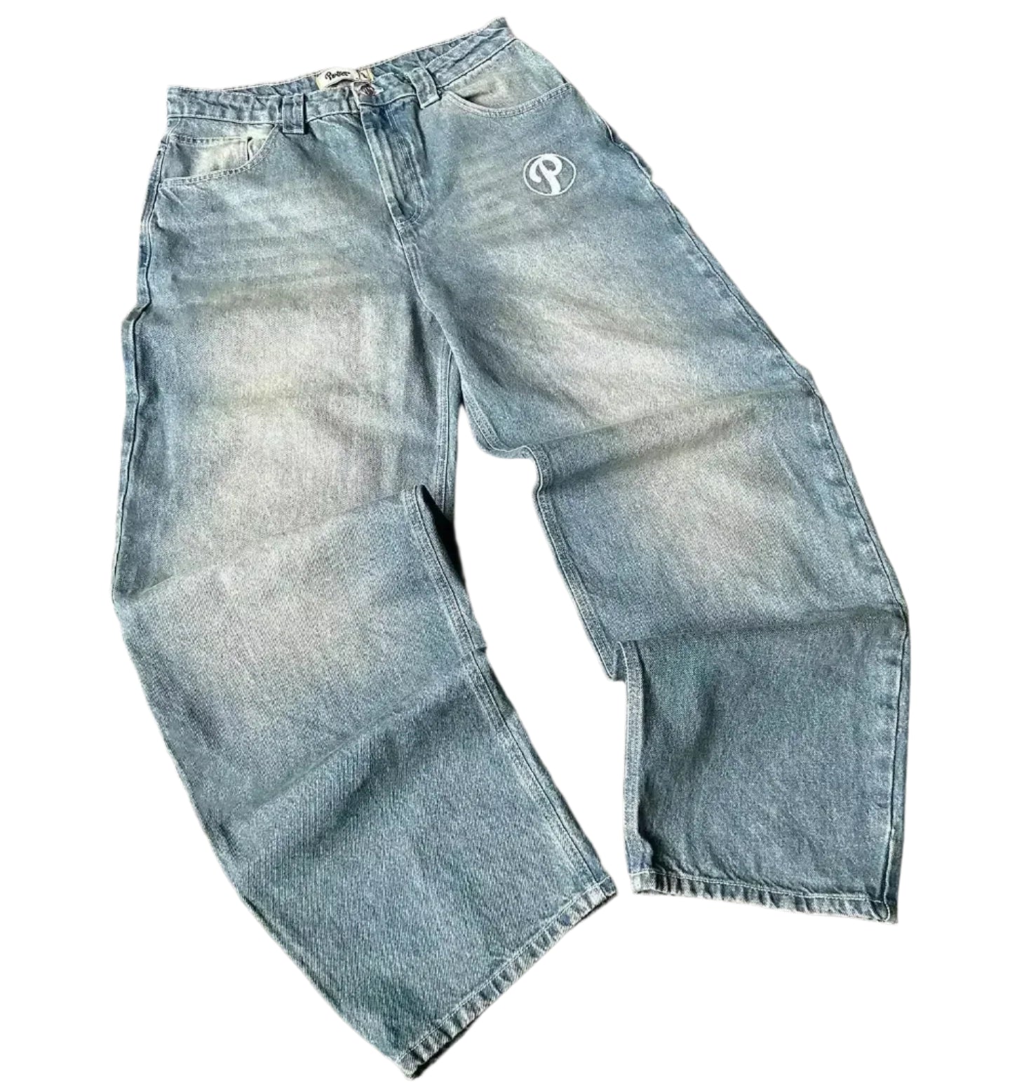 Blue jeans with a brand logo on a gray surface