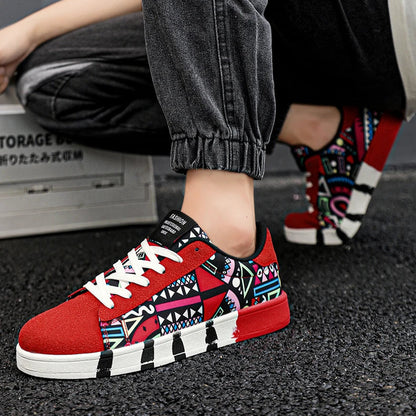 Person wearing red patterned sneakers with black pants and colorful socks.