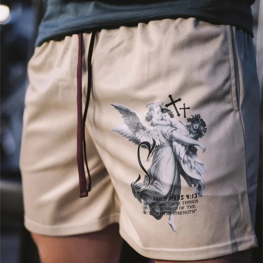 Beige shorts with an angel and cross design on a blurred background