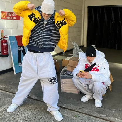 Two people in streetwear outfits in an urban setting