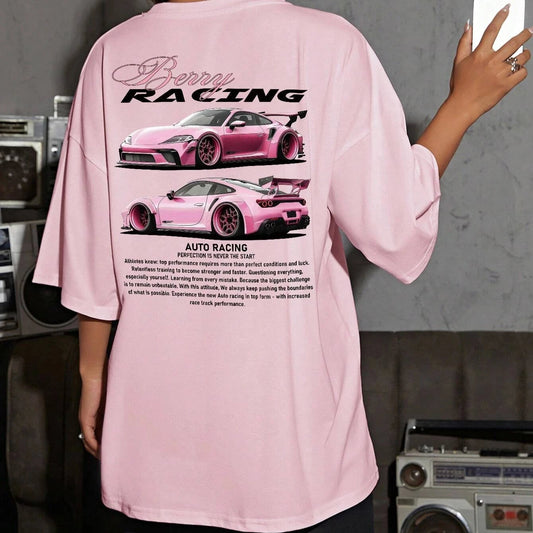 Person wearing a pink 'Auto Racing' t-shirt with car graphics in a room.