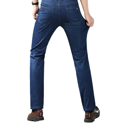 Person wearing blue jeans with a gray background