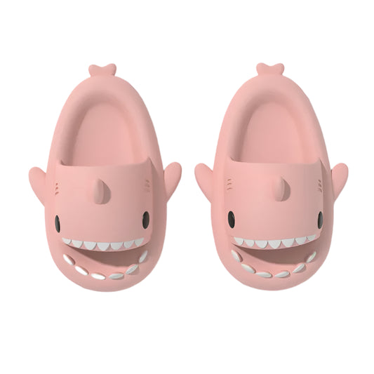 Pink shark-shaped slippers on a white background