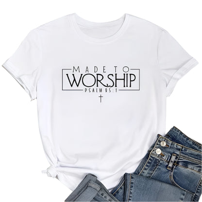 White t-shirt with 'Made to Worship' text on a wooden surface with jeans and sneakers.