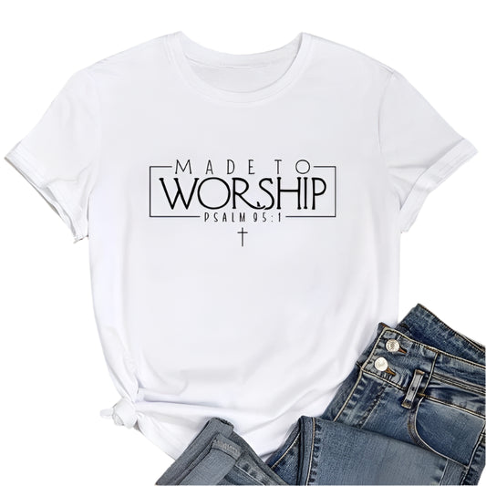 White t-shirt with 'Made to Worship' text on a wooden surface with jeans and sneakers.