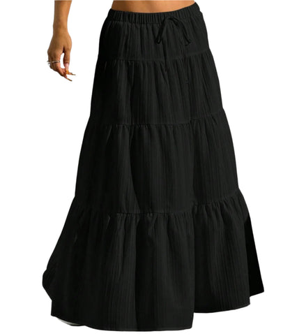 Black tiered skirt worn by a person against a plain background