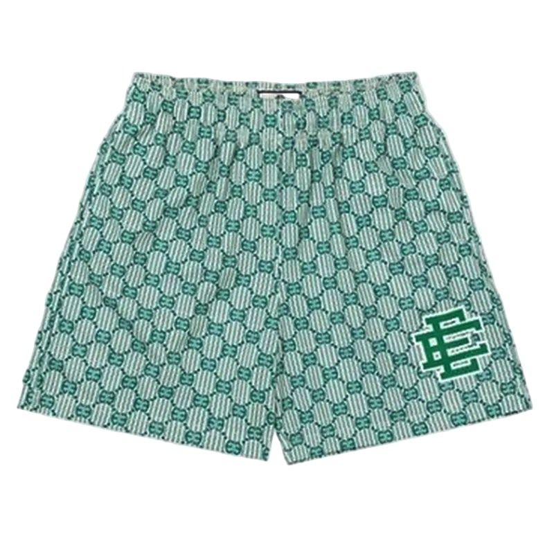 Green patterned shorts with a logo on a light gray background