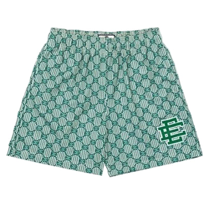Green patterned shorts with a logo on a light gray background