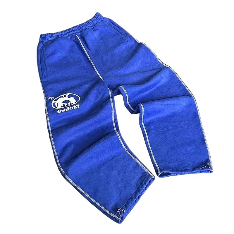 Blue pants with a logo on a gray surface