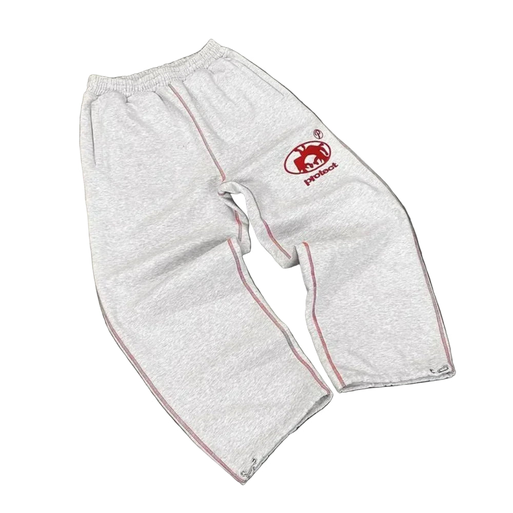 White protective pants with a red logo on a gray surface