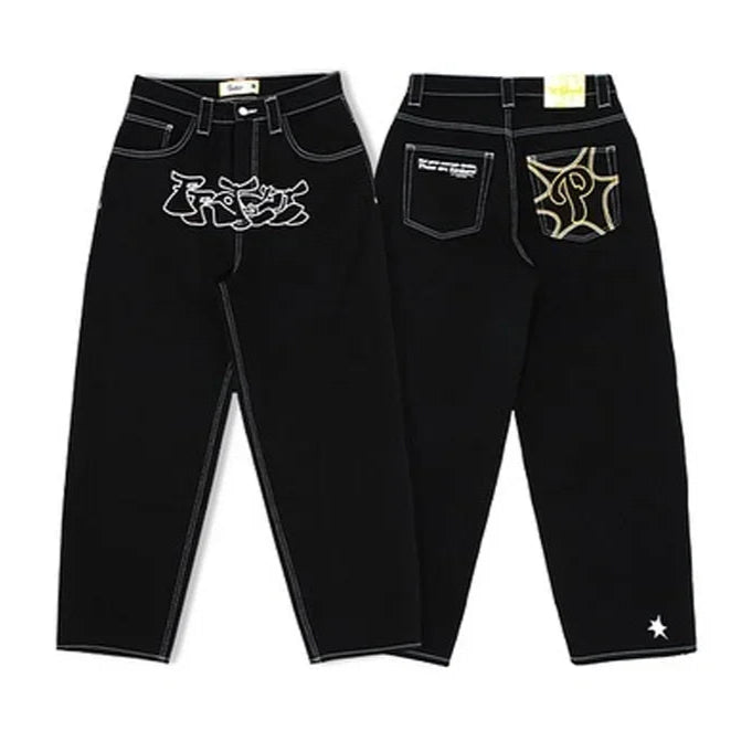 Pair of black jeans with embroidered designs on a white background