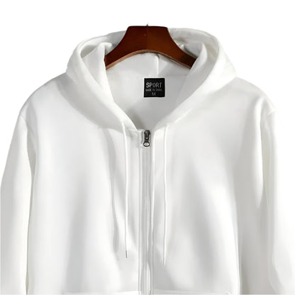 White hoodie with a brand label on a wooden hanger against a stone wall background