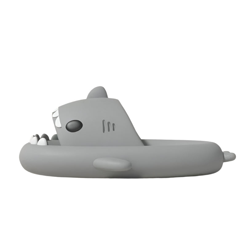 Gray shark-shaped inflatable pool float on a light pink background