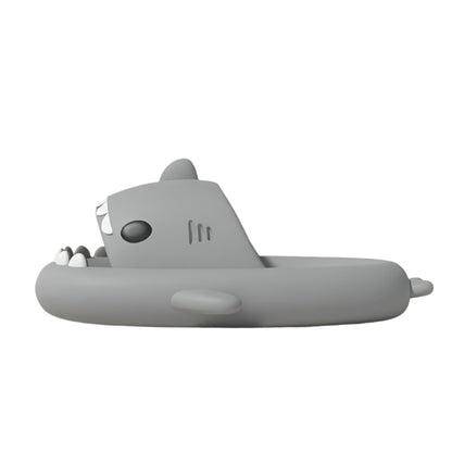 Gray shark-shaped inflatable pool float on a light pink background