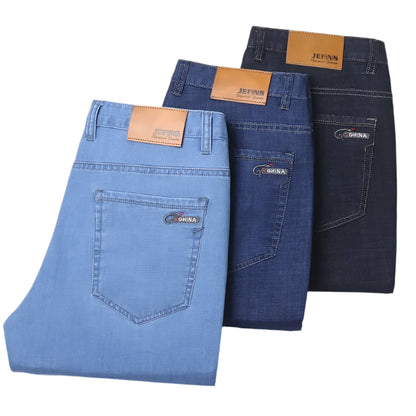 Three pairs of jeans in blue and black with visible brand labels on a white background