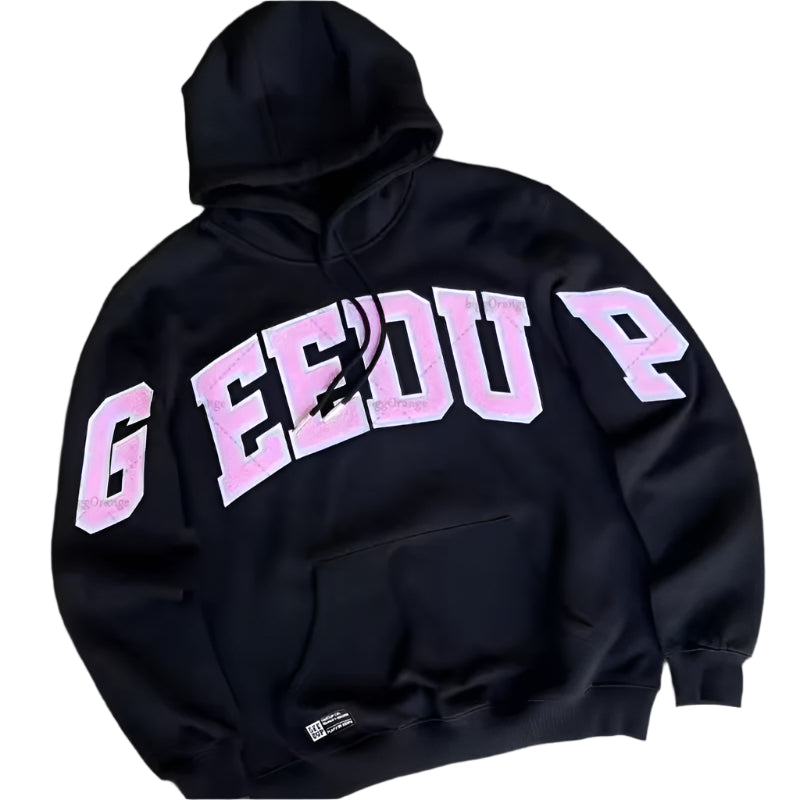 Black hoodie with pink text on a gray concrete surface