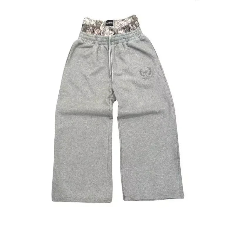 Gray sweatpants with a camouflage waistband on a white background