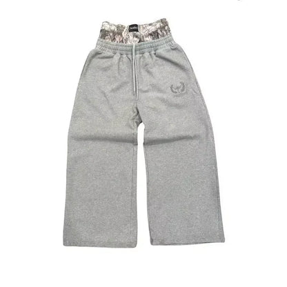 Gray sweatpants with a camouflage waistband on a white background
