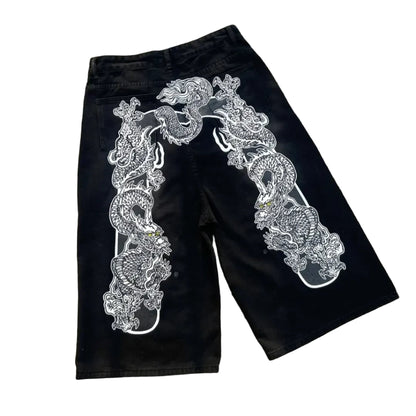 Black shorts with white intricate design on a concrete surface