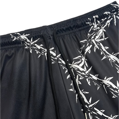 Black shorts with white barbed wire pattern on a white background